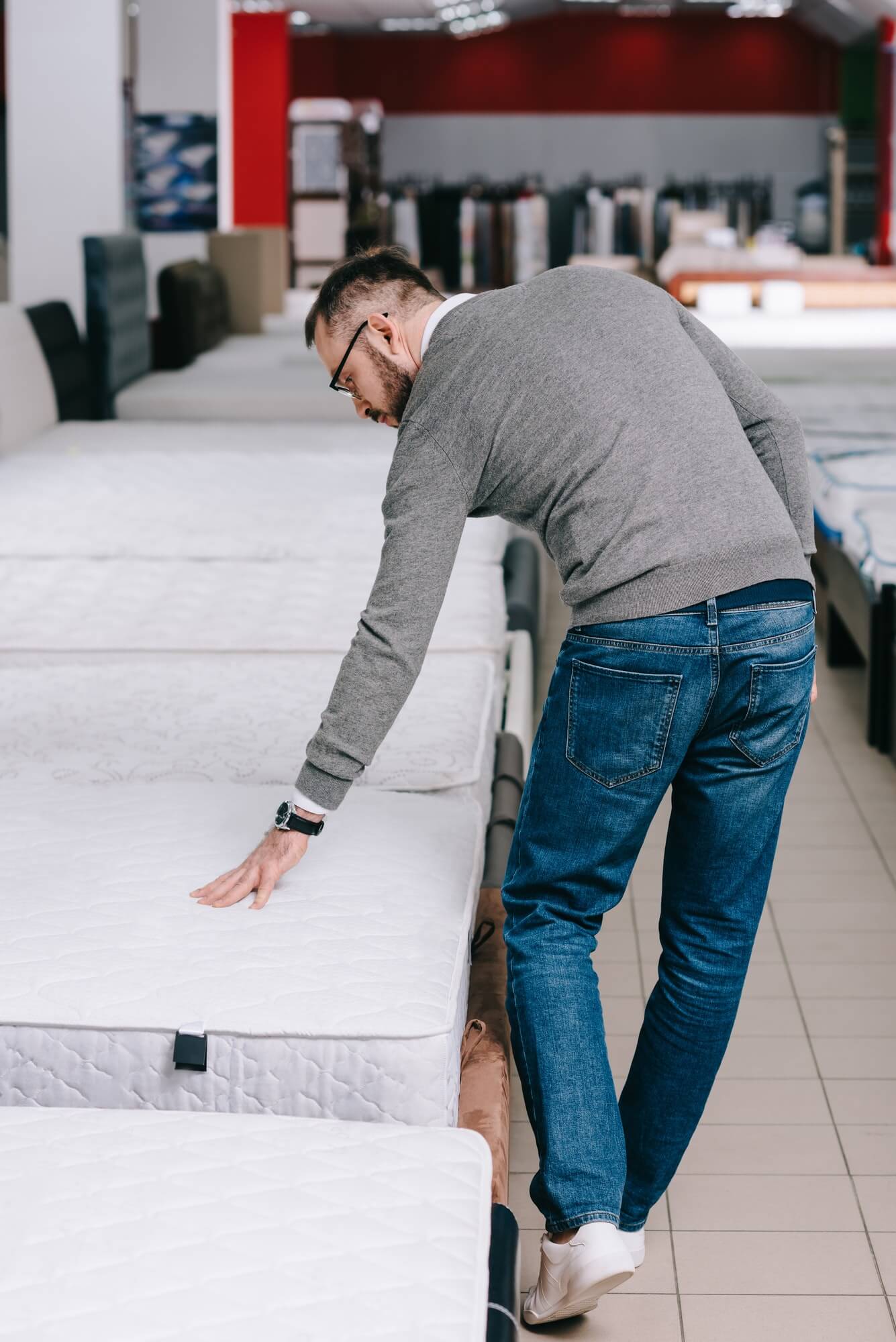 back-view-of-man-choosing-mattress-in-furniture-store-1.jpg